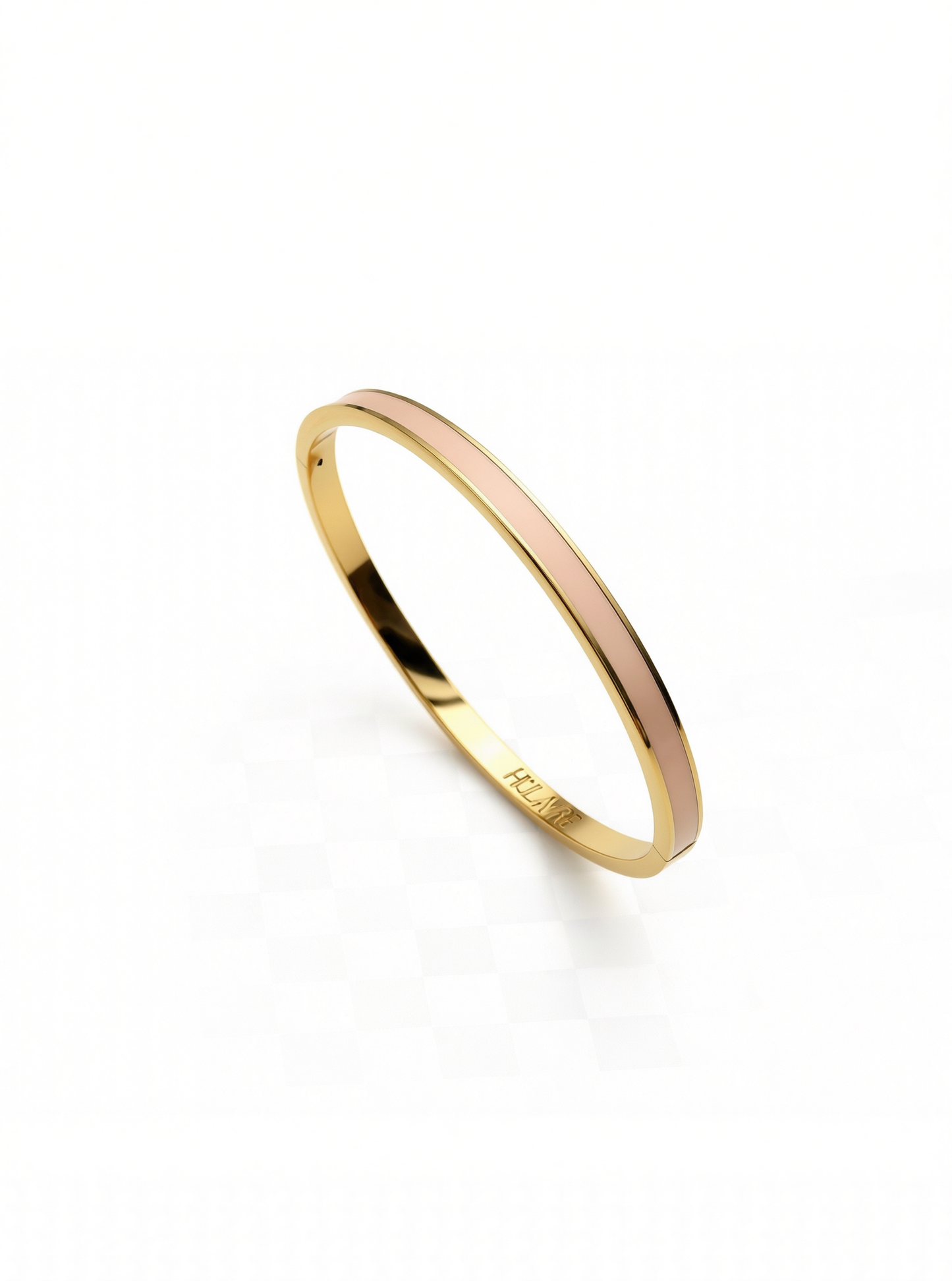 Layer bangle in 18k yellow gold with dusty pink enamel on a white background.